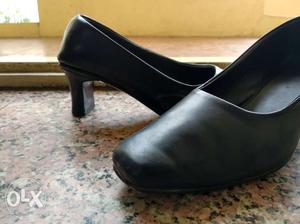 Pair Of Black Leather Heeled Shoes