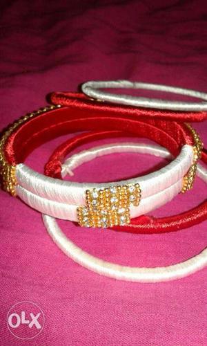 Several Red And White Bangle Bracelets