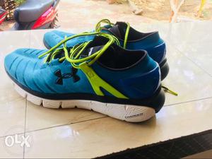 Pair Of Blue-and-green Under Armour Charged Shoes
