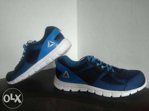 Pair Of Blue-and-white reebok Running Shoes