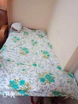 Single wooden cot with mattress