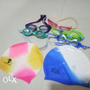 5 swimming goggles and 2 swimming caps for sale