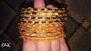 Black/ gold and orange/gold plated USED bangles