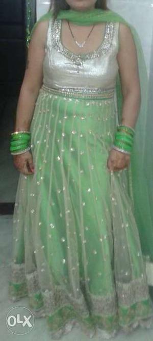 Green colour single piece dress with golden