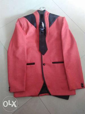 Red colour blazer with black shirt and tie for
