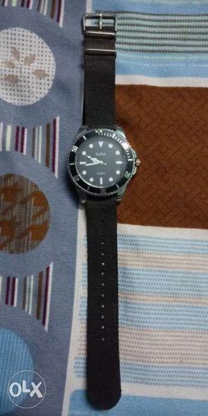 Round dial black watch in good condition for sale