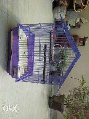 A complete bird cage with 2 food cups for the bird and a