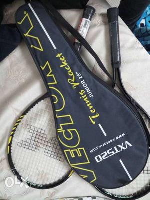 Two Black And Yellow Tennis Rackets