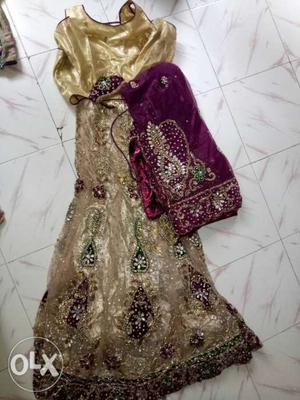 Beige and purple lehenga.Cold shoulder blouse and