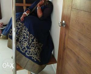Dark blue floor length gown with hand work and