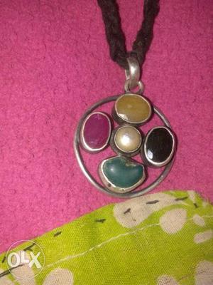 Round Gold-colored Pendant With Yellow, Black, Teal, And