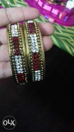 Two Gold-colored And Red Gemstone Bangles