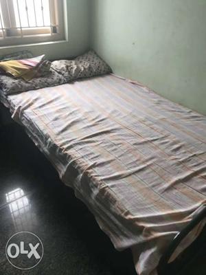 Single iron bed with a mattress