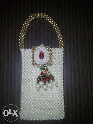 Gold and white coloured beaded phone pouch with key ring