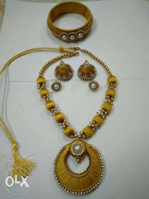 Golden color silk thread necklace with loreal