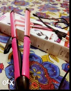 Hair straightener and curler pink colour.