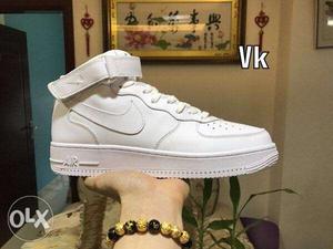Paired White Nike Air Force 1 High shoes