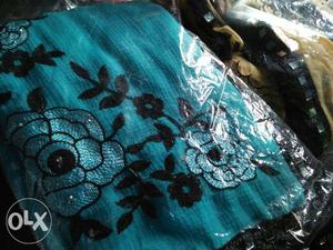 Teal And Black Floral Textile