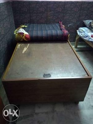 Brown wooden bed with mattresses