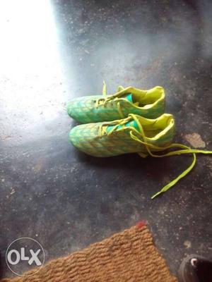 Pair Of Green-and-orange Cleats