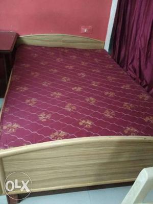 Red And Brown Mattress And Brown Wooden Bed Frame