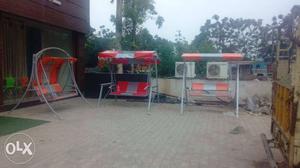 Three Red-and-gray Swing Benches