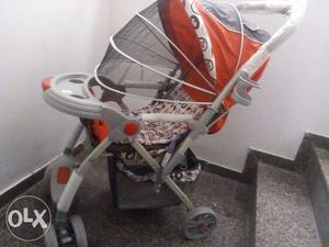 Baby's Orange And Gray Stroller