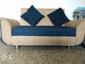 Brown And Blue Loveseat With Throwpillows