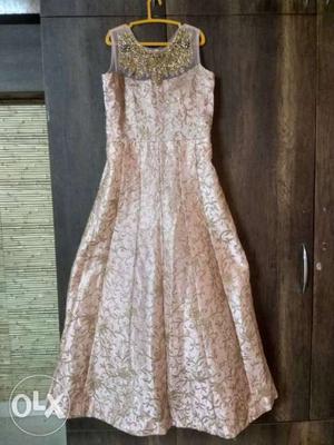 Light pink and golden full gown type dresss. Not