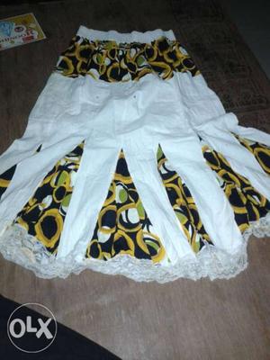 White, Yellow, And Black Floral Textile
