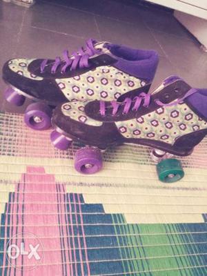 Pair Of Black-purple-and-white Rolling Shoes