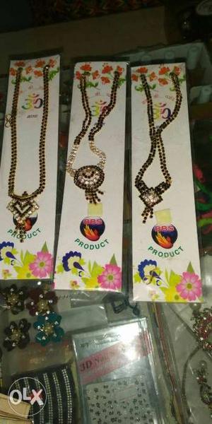 Three Gold-colored Chain Necklaces