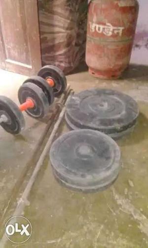 Two Black Dumbbells And Four Black Weight Plates