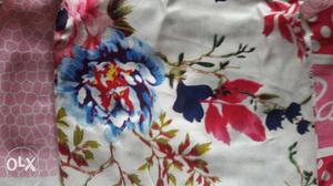 White, Blue, And Red Floral Textile