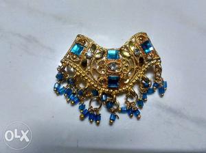 Gold-colored And Blue Gemstone Accessory