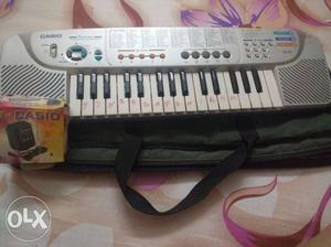 Gray Casio Electronic Keyboard With Case