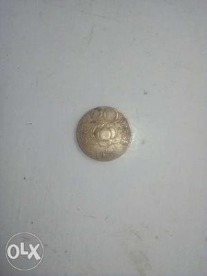 Old gold coloured 20 paise indian coin.