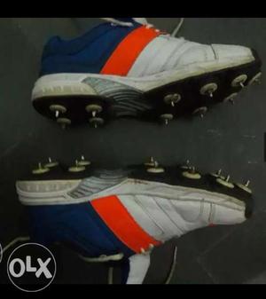 Pair Of White-and Orange cricket Shoes