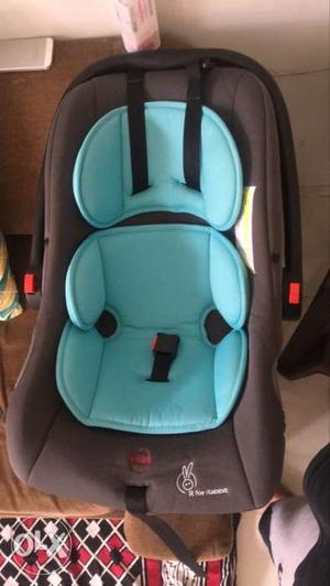 Baby's Blue And Black Car Seat