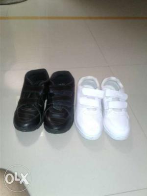 Two Pairs Of Black And White Shoes