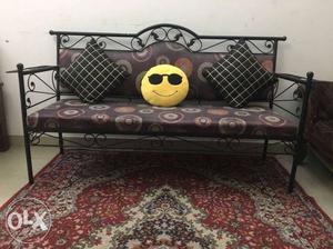 Brown Couch With Black Steel Frame And Throw Pillows