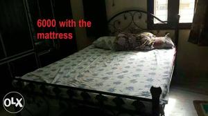 Double Bed Frame And White Mattress With Text Overlay