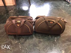 Two Brown And Black Duffel Bags