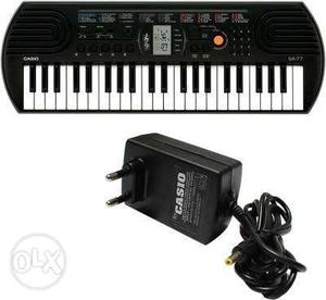 Black And White Casio Electric Keyboard With AC Adapter