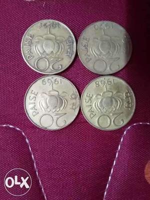Four Round Gold-colored 20 Indian Paise Coins