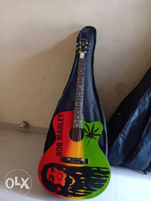 Red, Green, And Yellow Acoustic Guitar With Black Gig Bag
