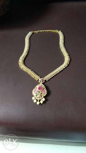 Gold-colored And Pink Gemstone Pendant Necklace
