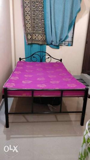 A Queen Sized Foldable Cot with a Matching