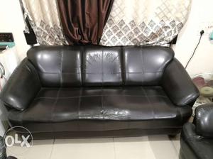 Black colour 5 seater sofa.