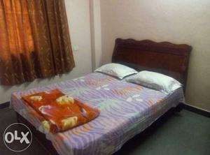 Queen size bed with mattress available for sale.